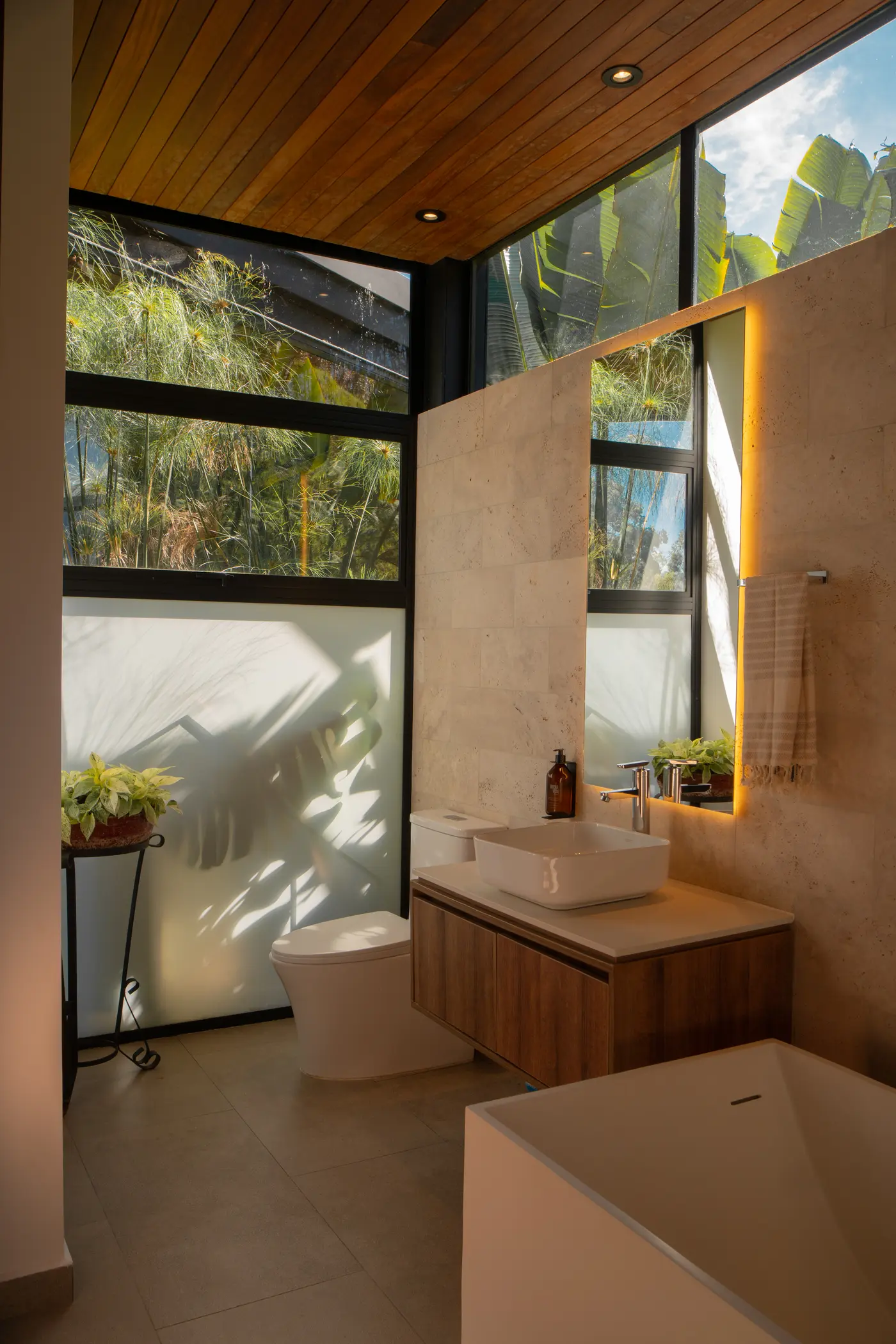 Modern bathroom with wood ceiling and rainfall shower