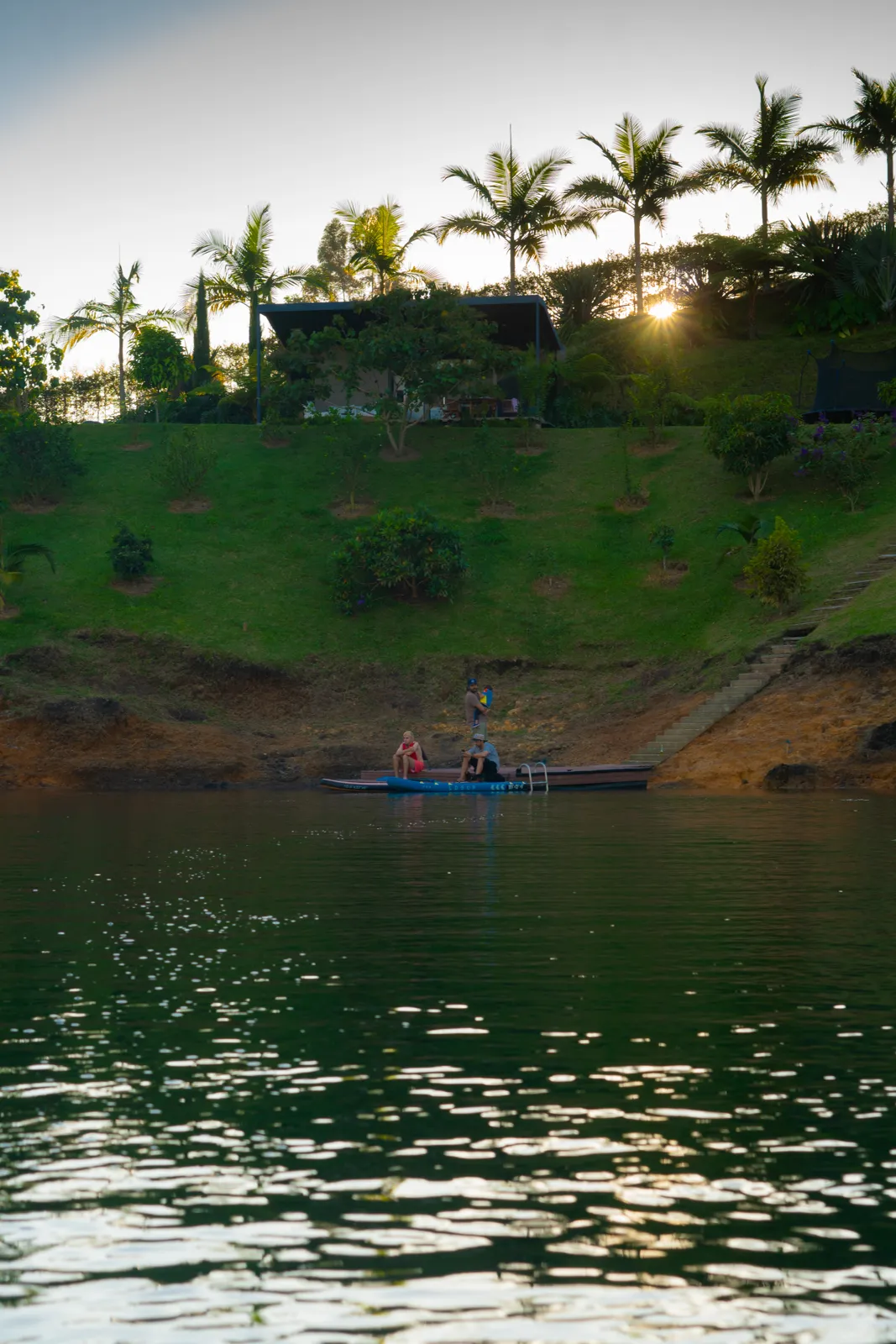 Private dock extending onto Lake Guatapé at golden hour