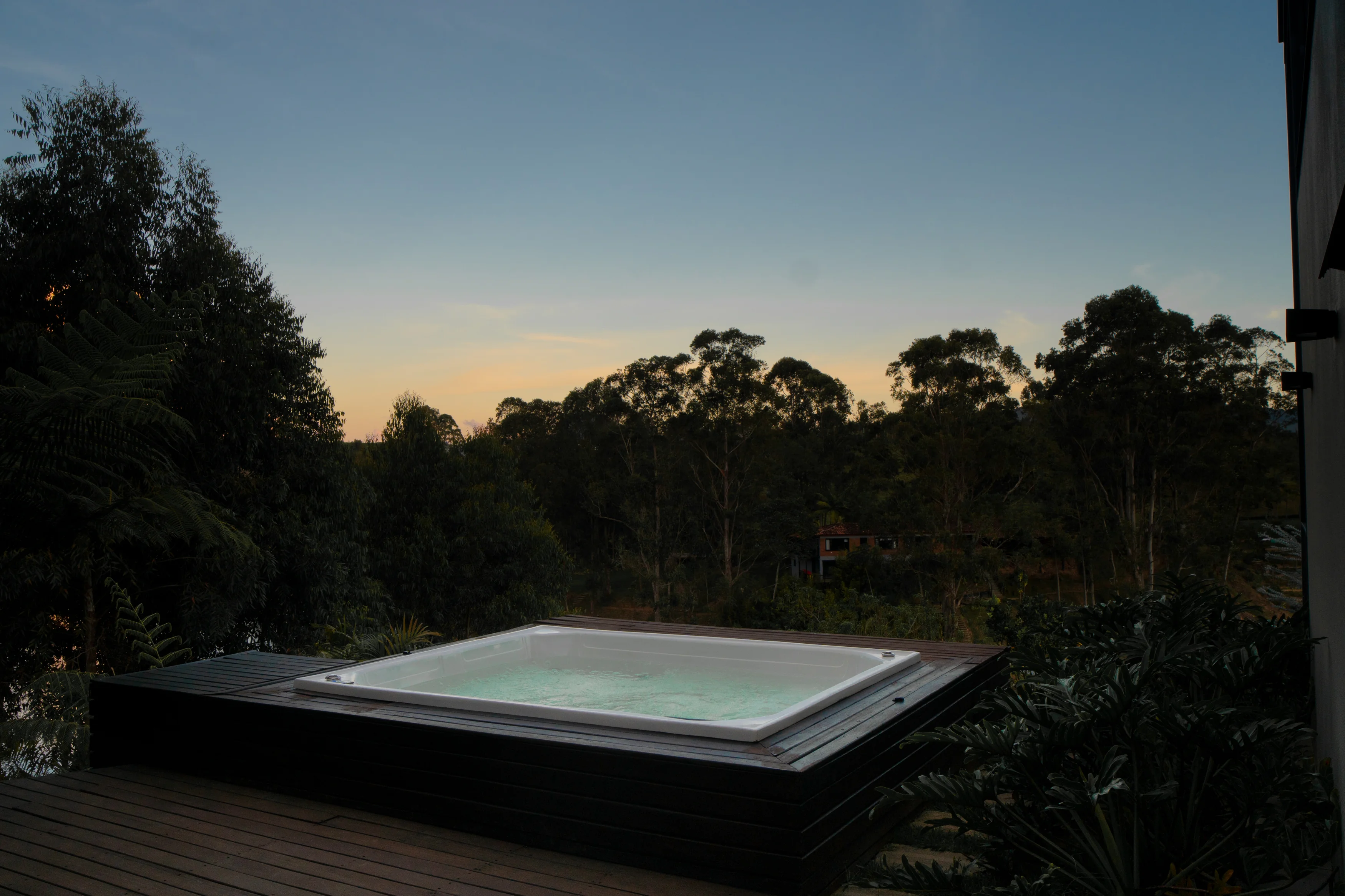 Jacuzzi at dusk with forest views