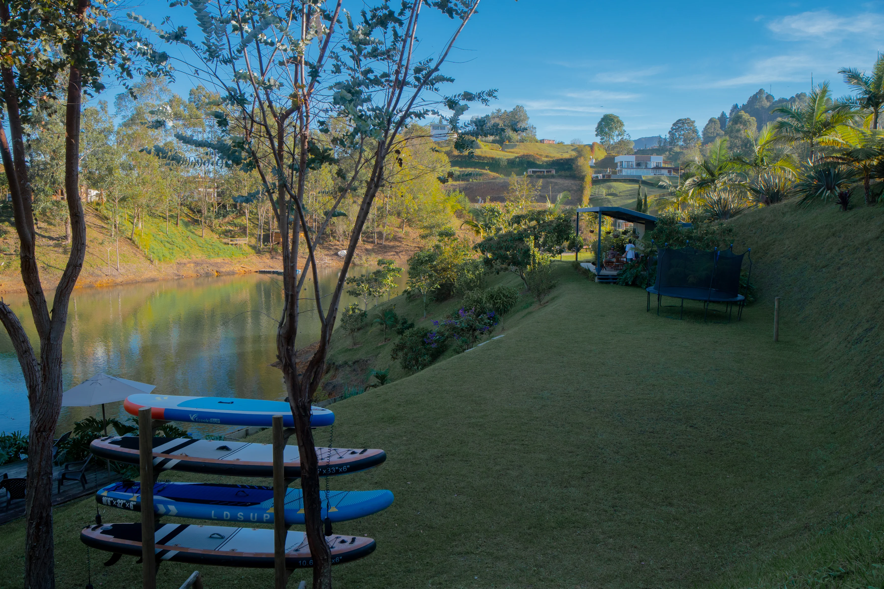 Lake panorama with paddleboards and trampoline
