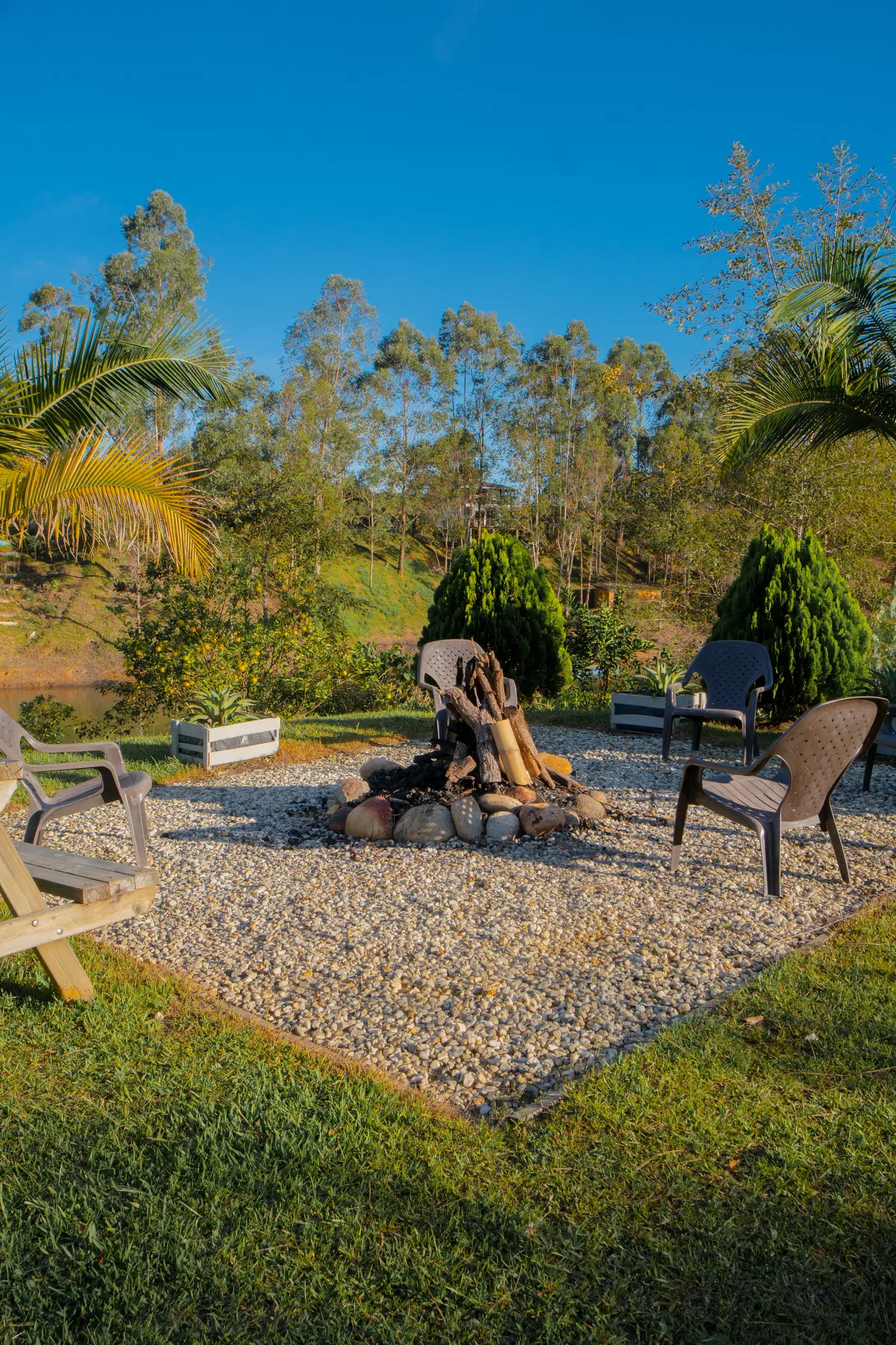 Fire pit area with lounge chairs at dusk